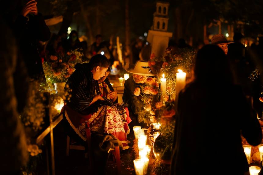 Candles burning in a cemetery at night
