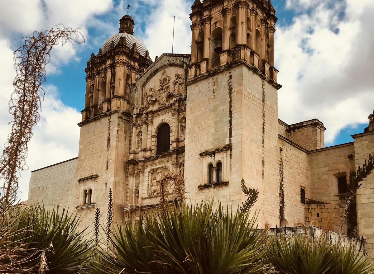 Santo Domingo church rising behind agaves in Oaxaca